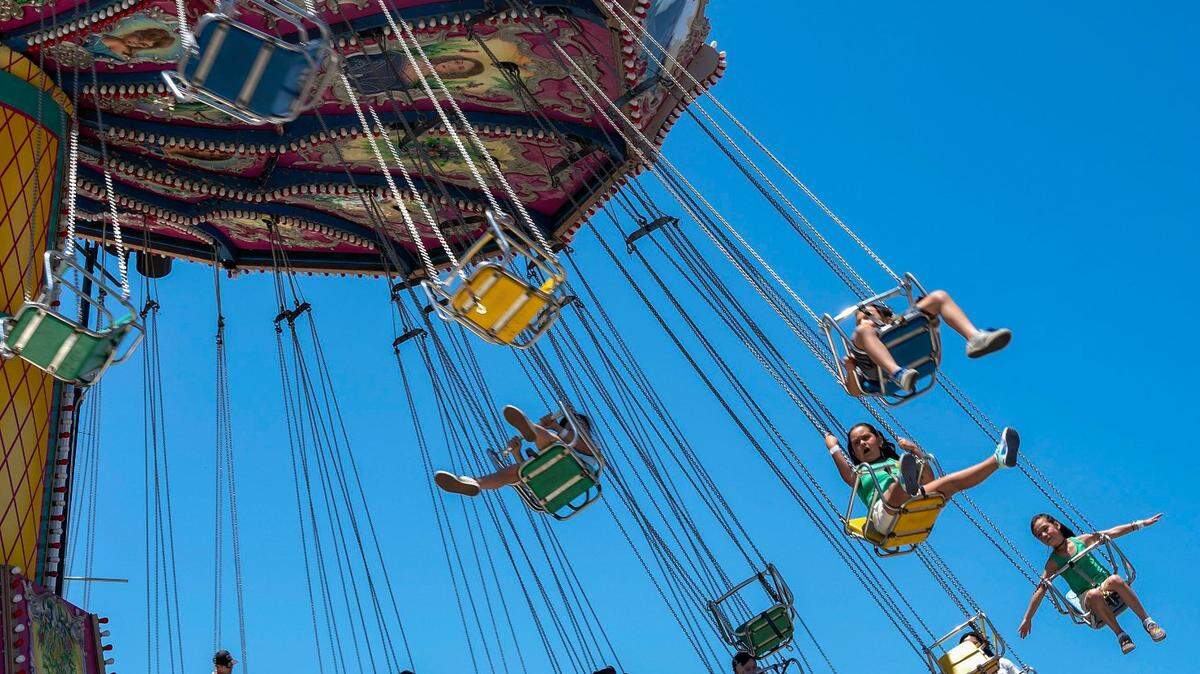 Guests ride the Wave Swinger ride at the California State Fair on Sunday, July 17, 2022, at Cal Expo.