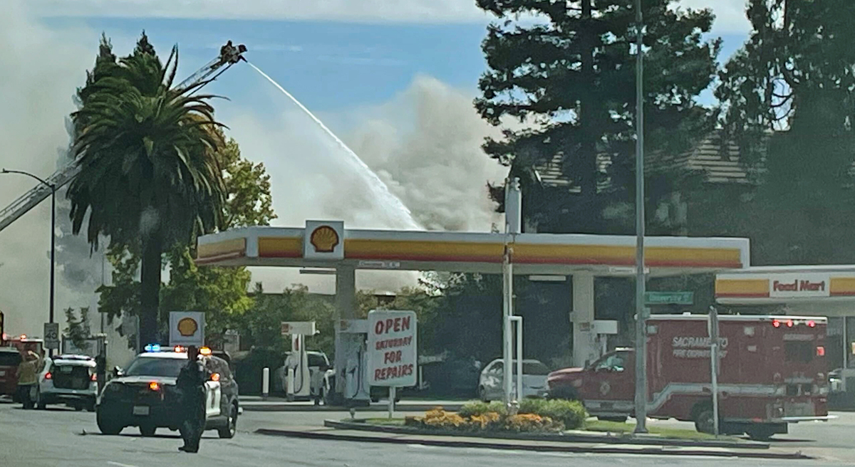 A firefighter on a ladder truck sprays flames at a shuttered Boston Market location on the 2300 block of Fair Oaks Boulevard in Arden Arcade on Sunday.