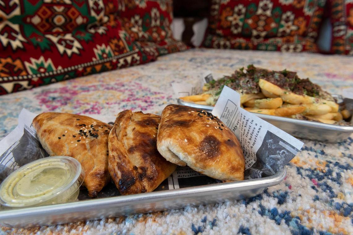Tandoor Samosas, front, and Khan fries from Madar, an Afghani-fusion street food restaurant, on Thursday, June 18, 2020. The dough for the Samosas is bought from a local bakery.