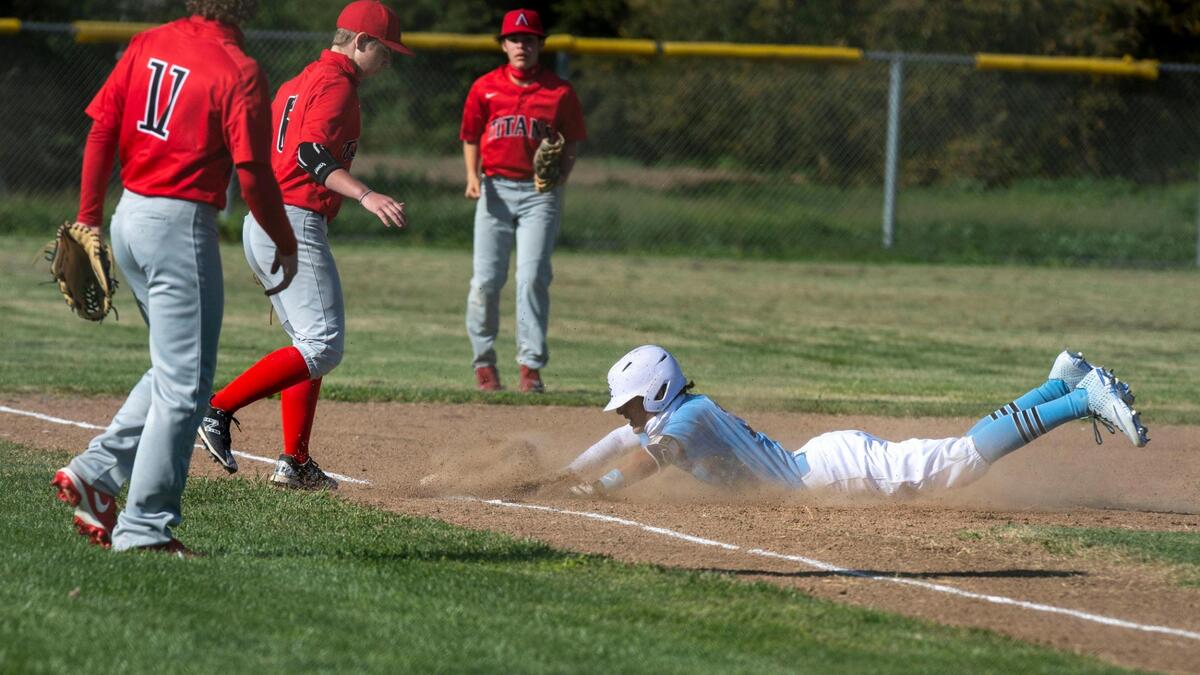 River City High School second baseman Lance Sabatke slides into third base as the Raiders take on Titans on Monday, March 29, 2021, at River City High School in West Sacramento.