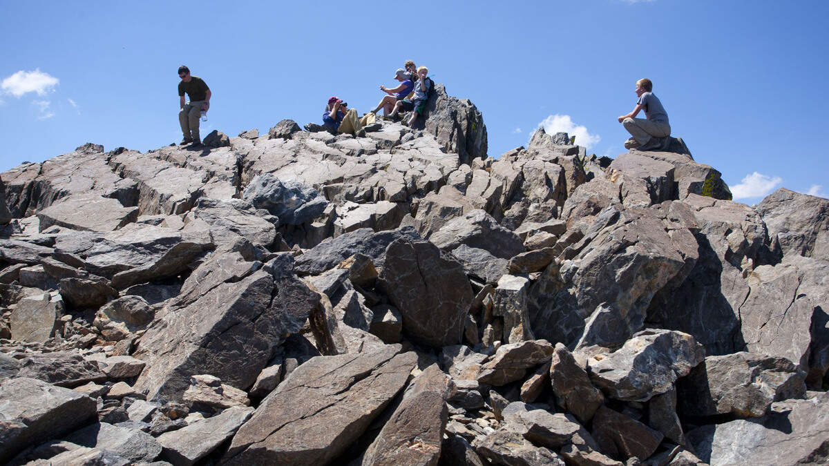 Hikers take pictures on the summit of Mount Tallac in Lake Tahoe. Climbing on national wilderness land, which includes much of the Lake Tahoe area, would be subject to local regulations under the National Forest Service’s new policy.