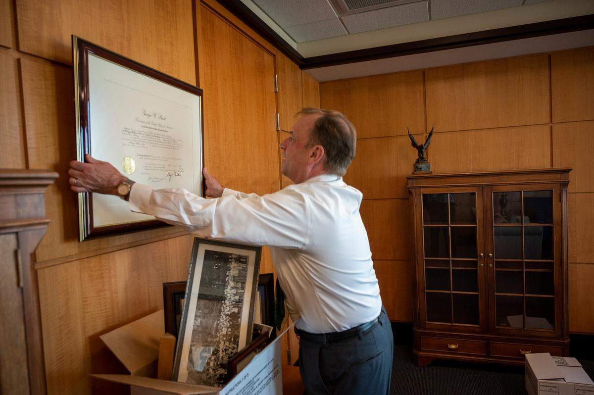 U.S. Attorney McGregor Scott removes his framed presidential commission, signed by George W. Bush on his first appointment as a U.S. attorney, while packing up his office Feb. 24, 2021, after serving two stints as the Sacramento region’s highest-ranking federal law enforcement officer.