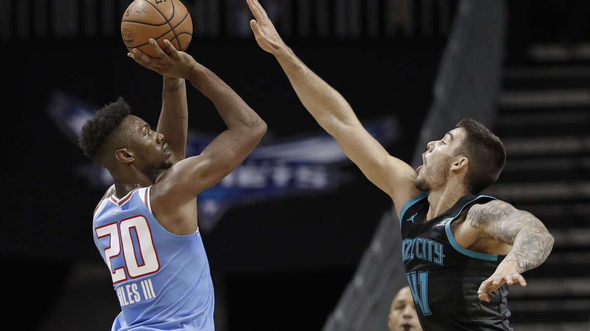 Sacramento Kings’ Harry Giles (20) shoots over Charlotte Hornets’ Willy Hernangomez (41) during the first half of an NBA basketball game in Charlotte, N.C., Thursday, Jan. 17, 2019. (AP Photo/Chuck Burton)