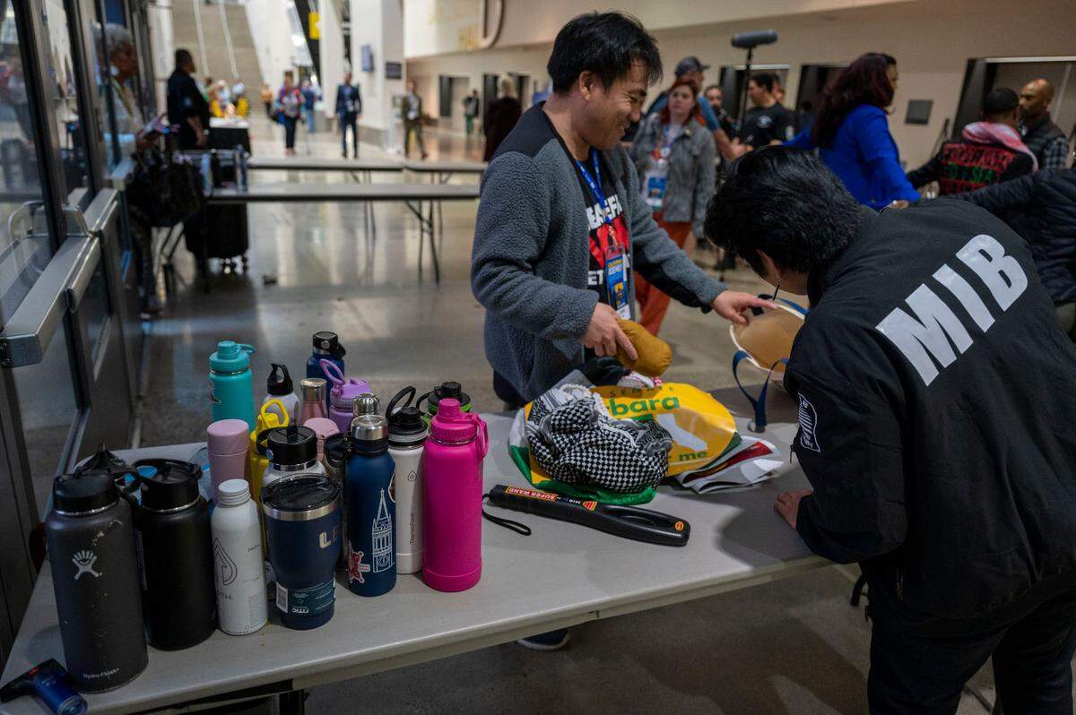 Reusable water bottles are held at a security check point at the entrance of the 2023 California Democratic Party November State Endorsing Convention on Saturday at SAFE Credit Union Convention Center in Sacramento.