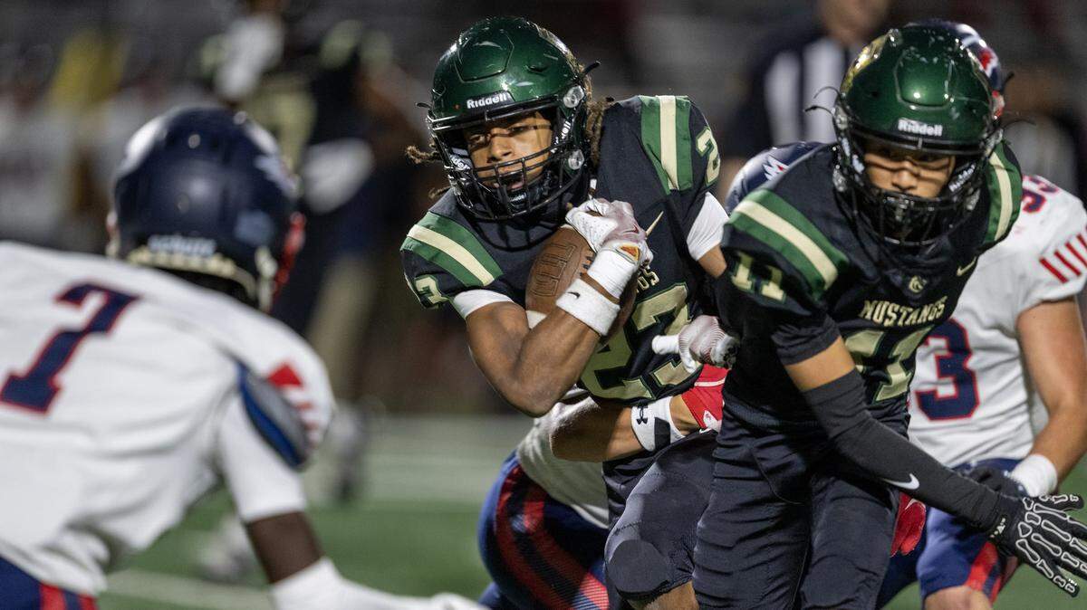 Monterey Trail Mustangs' Albert Dennis (22) runs for a short gain in the first half against the Pleasant Grove Eagles on Friday, Oct. 3, in Elk Grove.
