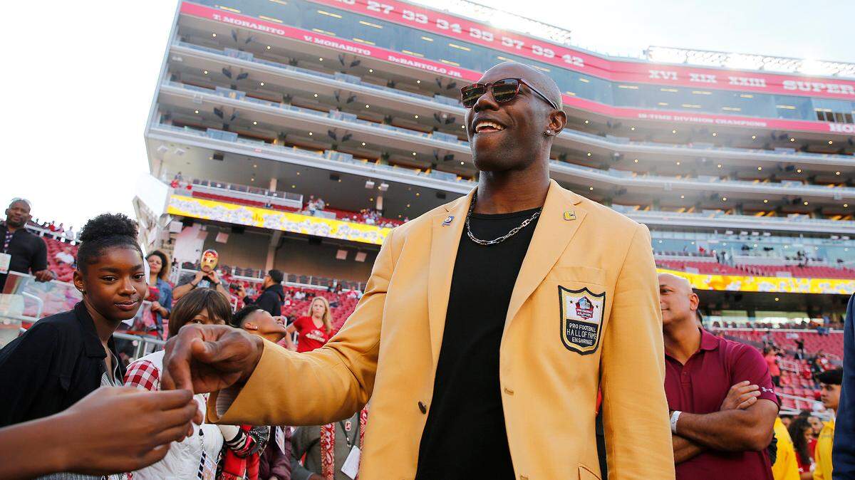 Terrell Owens, wearing his Pro Football Hall of Fame gold jacket, mingles with fans at the San Francisco 49ers-Oakland Raiders game at Levi’s Stadium on Nov. 1.