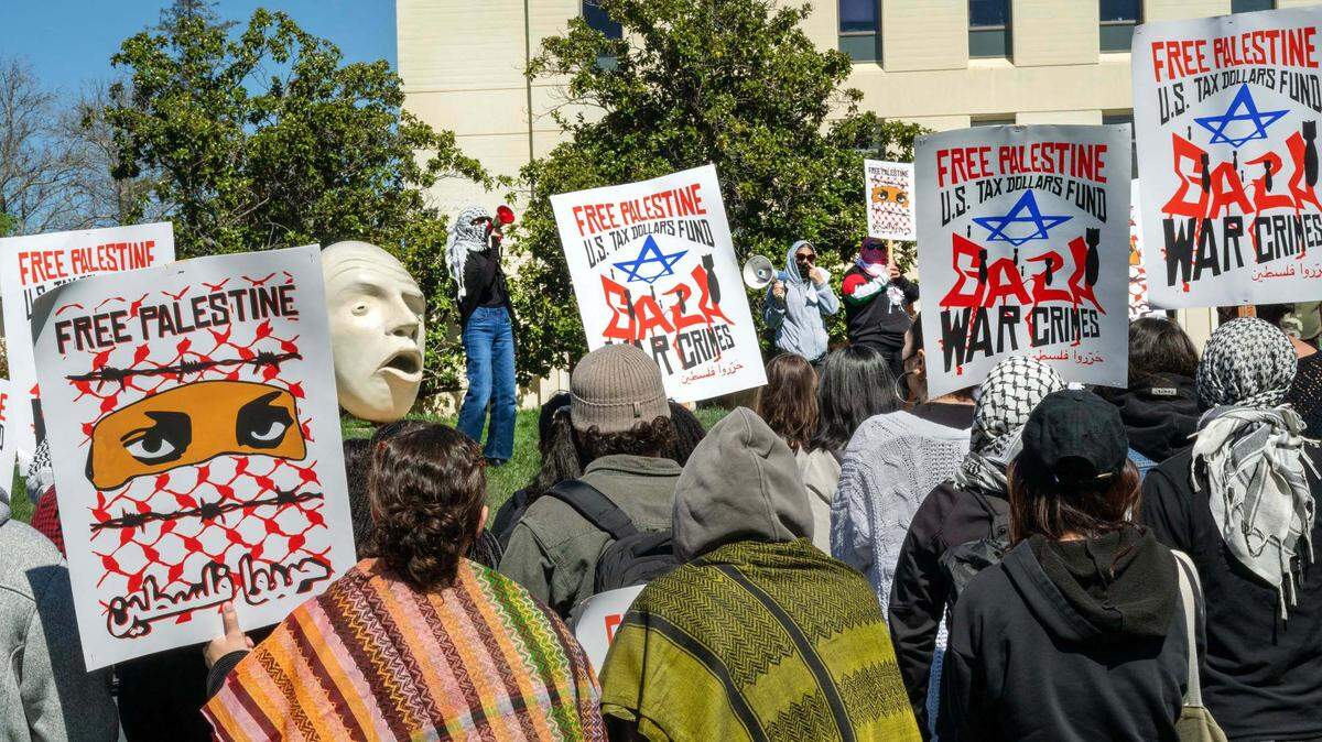 Campus protests condemning Israel’s attacks on Gaza have led the U.S. to cancel some student visas. Here, UC Davis students stage a walkout in front of King Hall on April 2, 2025.