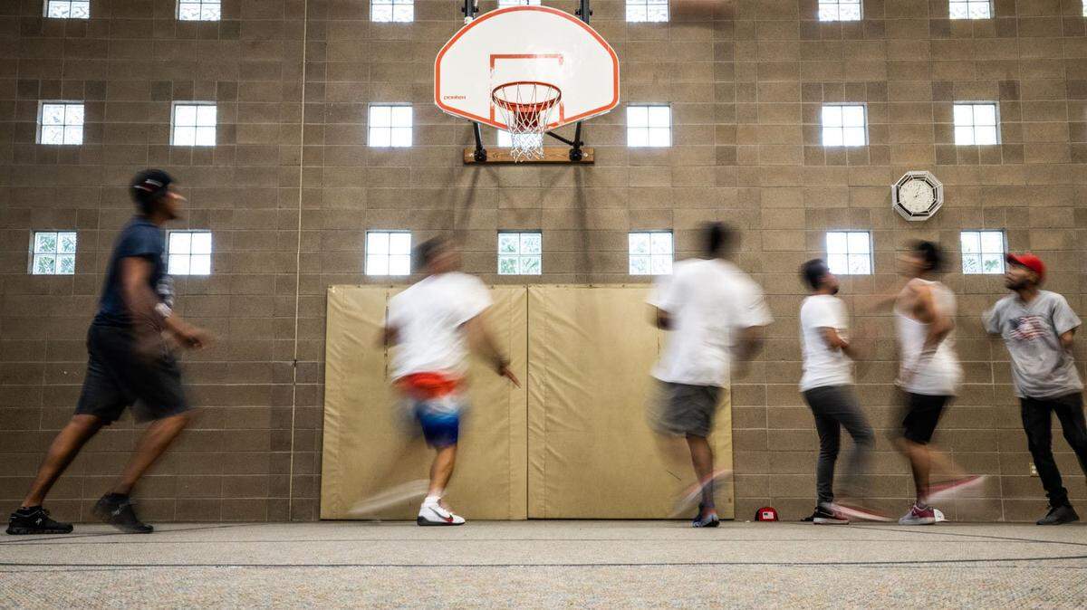 Migrants transported in June by the state of Florida to Sacramento play basketball Thursday during a day of activities at a local church.