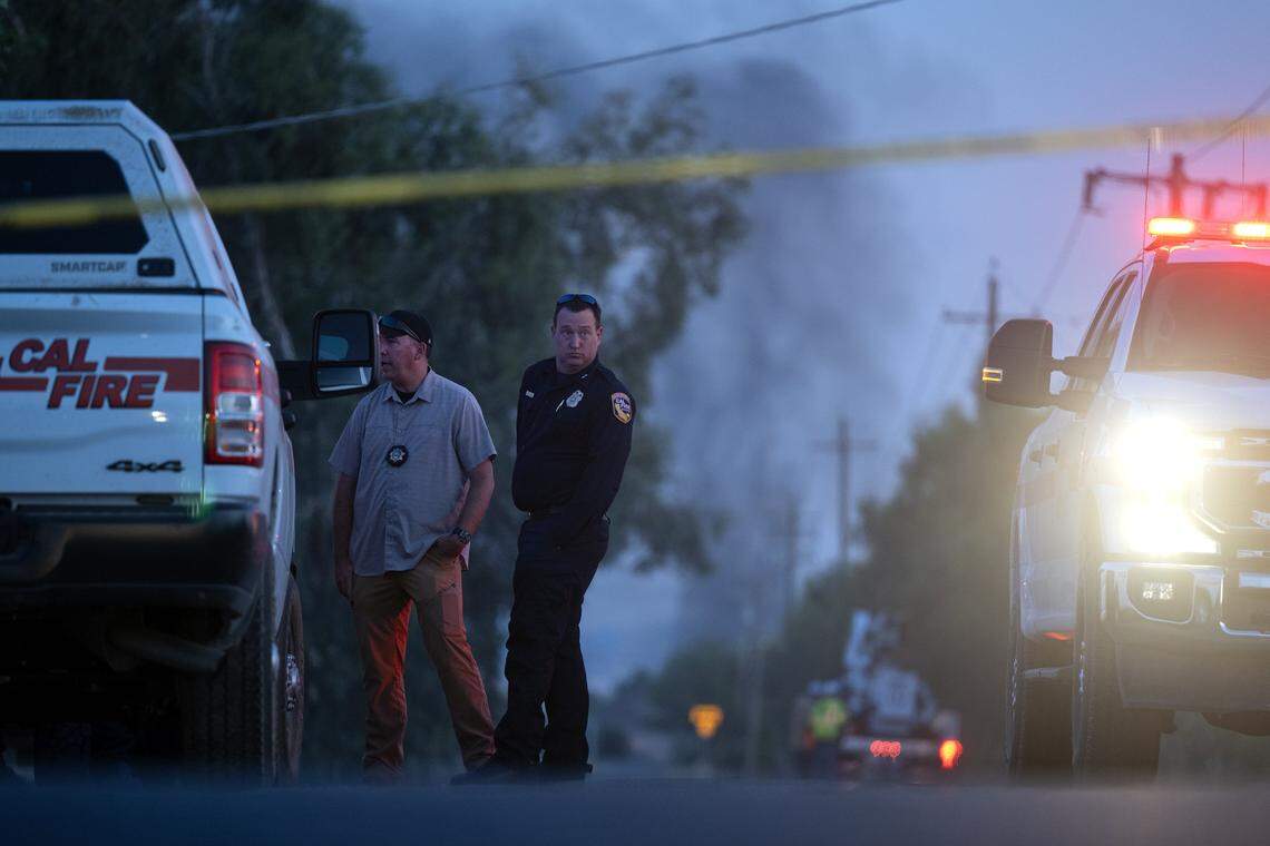 Emergency crews gather July 1 at Highway 16 and County Road 86A in Esparto as smoke rises from the fireworks explosion site.