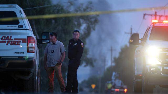 Emergency crews gather July 1 at Highway 16 and County Road 86A in Esparto, near the location of a fireworks explosion on a warehouse on County Road 23.