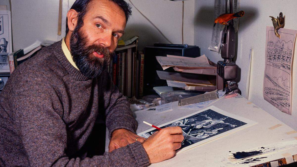 Sacramento Bee editorial cartoonist Dennis Renault draws a cartoon in his Bee office. His work appeared in The Sacramento Bee from 1971 to 1998.