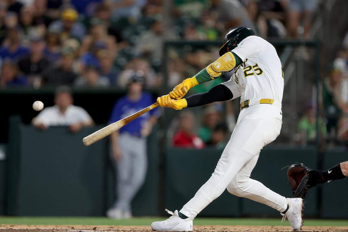 Jul 12, 2025; West Sacramento, California, USA; Athletics designated hitter Brent Rooker (25) hits a two run home run against the Toronto Blue Jays during the fifth inning at Sutter Health Park. Mandatory Credit: Dennis Lee-Imagn Images