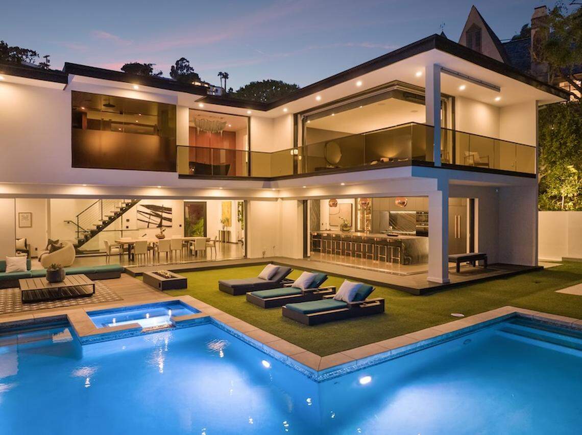 The gated 6,000-square-foot Sunset Strip stunner sits on an expansive hillside lot with a large yard and swimming pool, spa, outdoor kitchen and firepit.