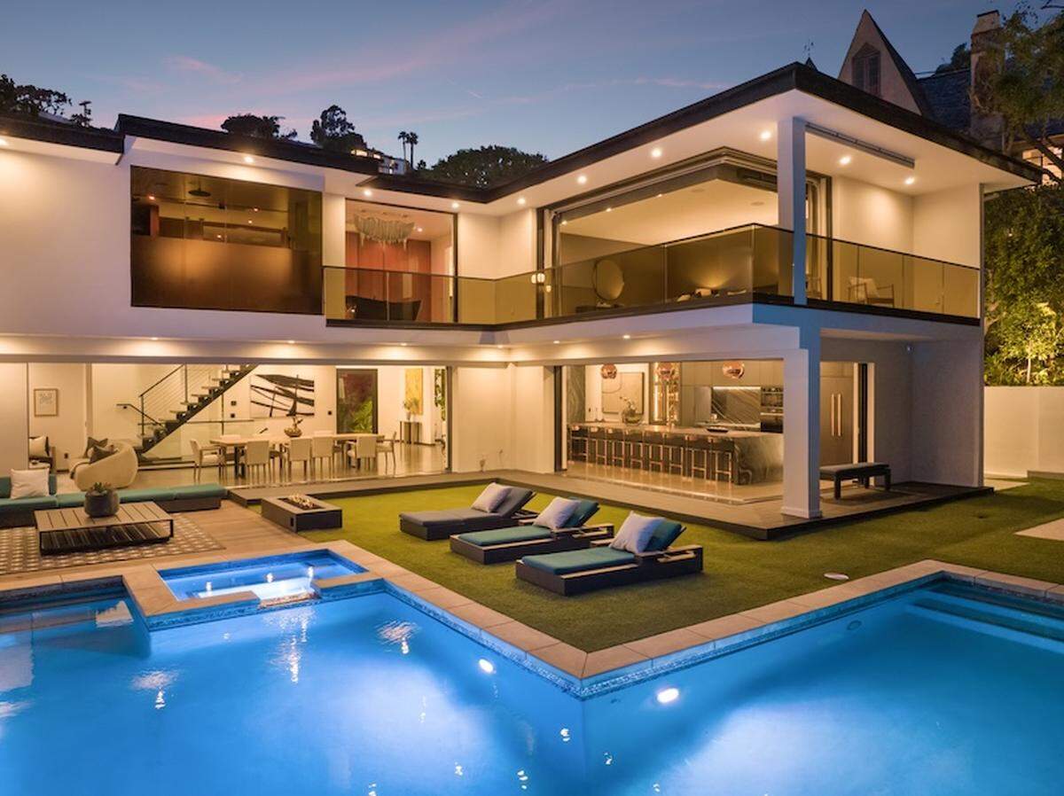 The gated 6,000-square-foot Sunset Strip stunner sits on an expansive hillside lot with a large yard and swimming pool, spa, outdoor kitchen and firepit.