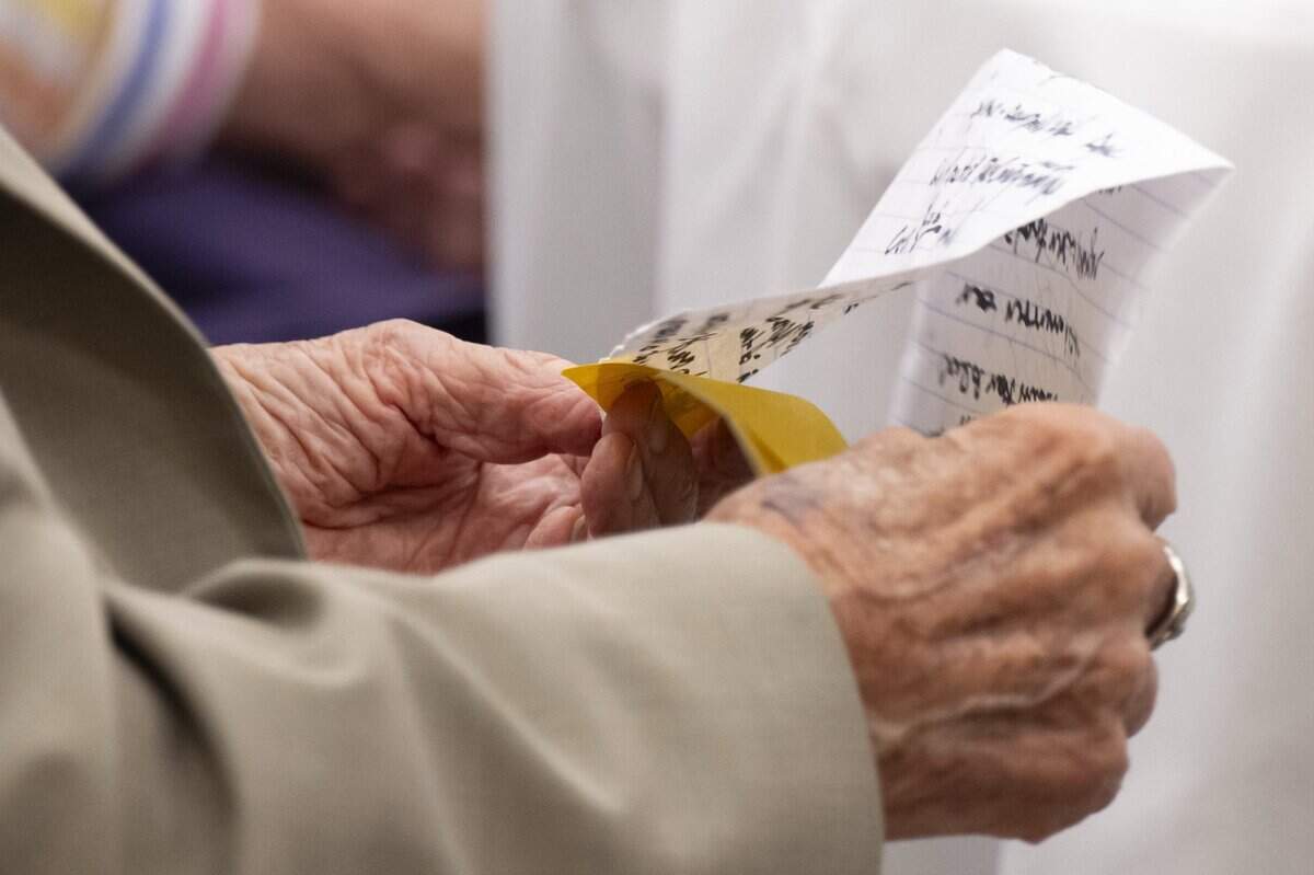 Former Sacramento Rotary Club President Bob Cole looks at his notes while waiting to be honored for his 75 years of membership and service to the club on Tuesday. Cole is a 103 year-old Marine Corps veteran who served during World War II, and his family legacy with the rotary club spans 3 generations.