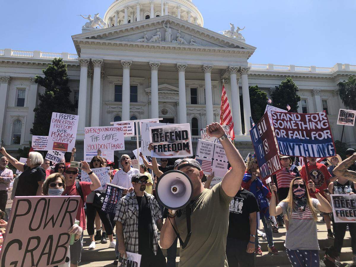 Lee Williams chants “open up” at a protest against Gov. Gavin Newsom’s stay-at-home order at the California Capitol on Friday, May 1, 2020, in Sacramento.