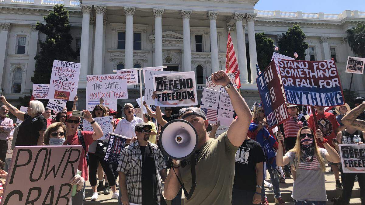 Cordie Williams chants “open up” at a protest against Gov. Gavin Newsom’s stay-at-home order at the California Capitol on Friday, May 1, 2020, in Sacramento.