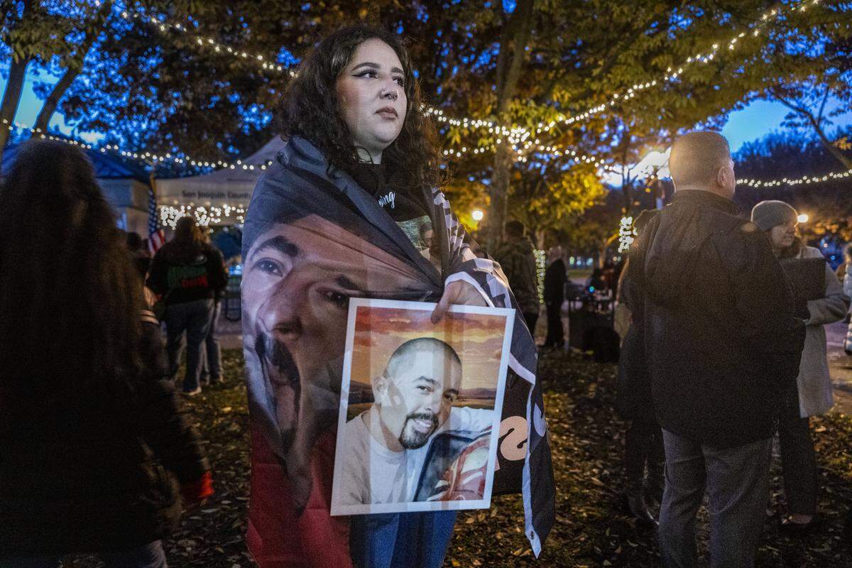 Alena Leal holds a photo of her father Jose while attending an annual Stockton candlelight vigil for victims of violence on Wednesday. Leal's father was killed in a stabbing in 2023. 