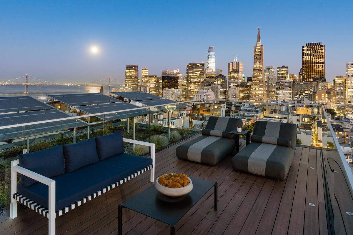 The property’s luxurious features include a car elevator to private underground parking, a landscaped rear yard, solar panels, and a spectacular roof deck with 360-degree vistas.