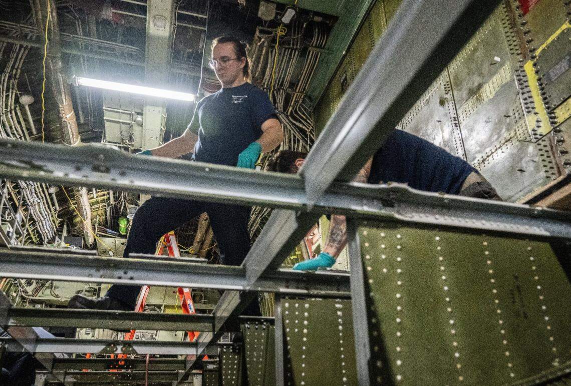 A Cal Fire employee works on the interior of a 1984 C-130H air tanker on Thursday. The aircraft is being retrofitted to hold a 4,000-gallon tank for flame retardant.