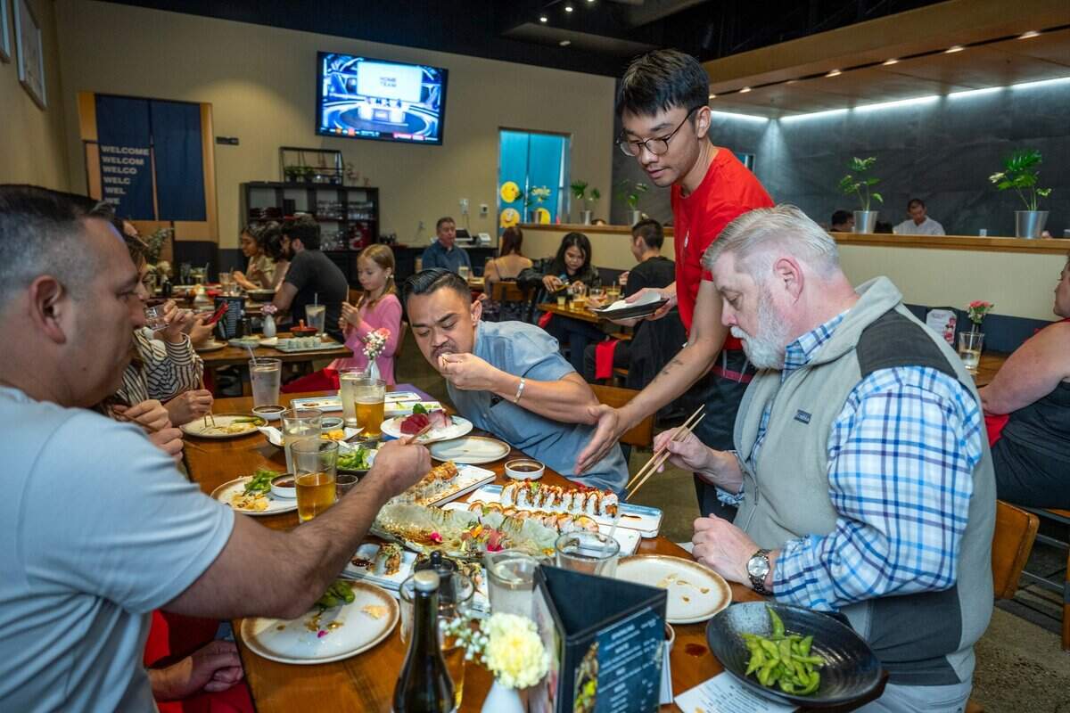 Waiter Cody Jie serves up sushi rolls to customers Travis Maley, right, and Chad Ortega, center, last month at Chef Frank Japanese Cuisine in North Natomas.