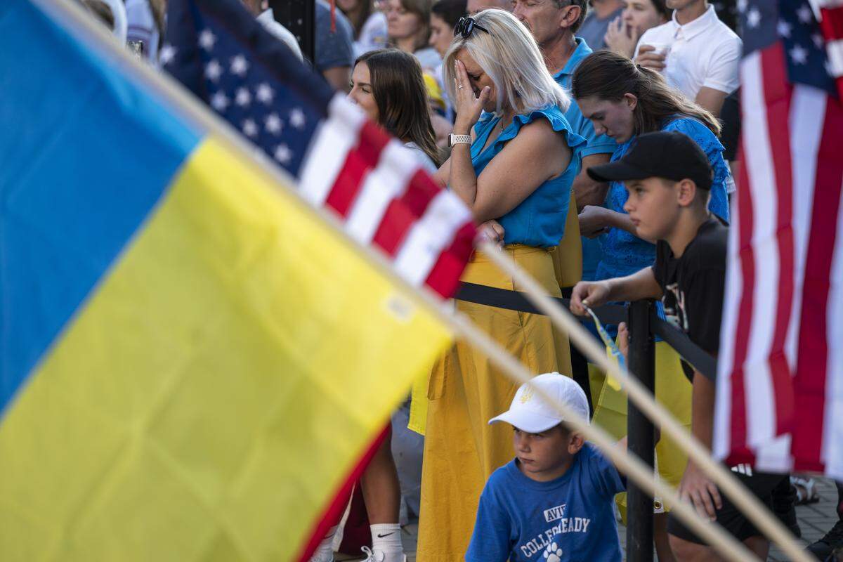 Ukrainian Americans react to a video message from Ukrainian President Volodymyr Zelenskyy during a Ukrainian Independence Day celebration at the California Capitol in Sacramento on Sunday.