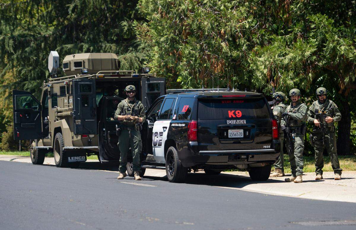 Police and sheriff’s units stand guard on Greenbrae Road in Rocklin on Sunday, July 9, 2023, after a potential sighting of the Mahany Park murder suspect Eric James Abril, who escaped earlier in the day from a Roseville hospital.