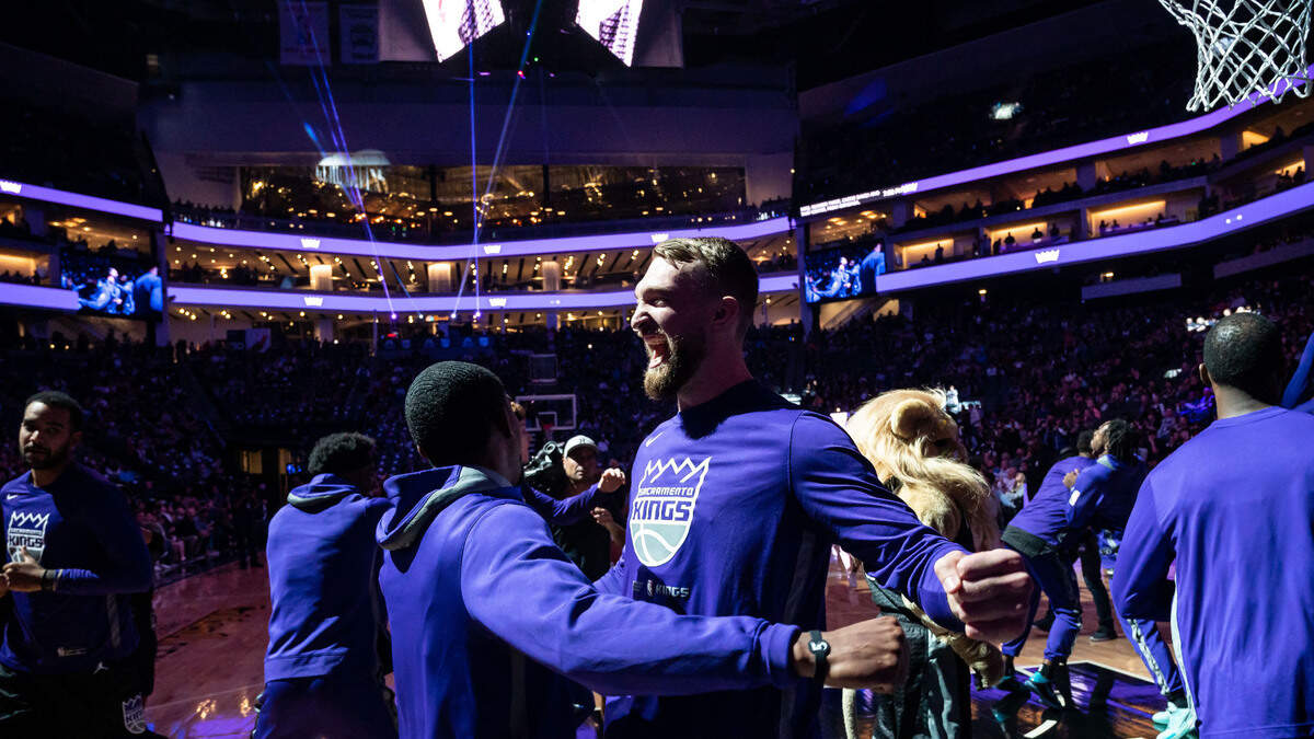 Sacramento Kings center Domantas Sabonis (10) and guard De’Aaron Fox (5) chest bump as the starting team is introduced before their NBA basketball game against the San Antonio Spurs on Thursday, Nov. 17, 2022, at Golden 1 Center in Sacramento.