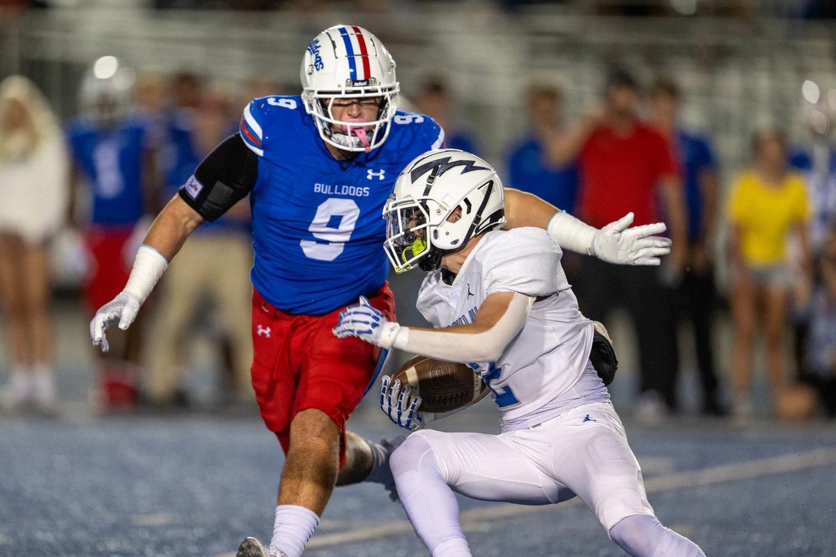 The Folsom Bulldogs’ Theo Greule (9) brings down the Rocklin Thunder’s Rafi Merino in the backfield in September. The four-year starter is one of The Bee’s co-Defensive Players of the Year.