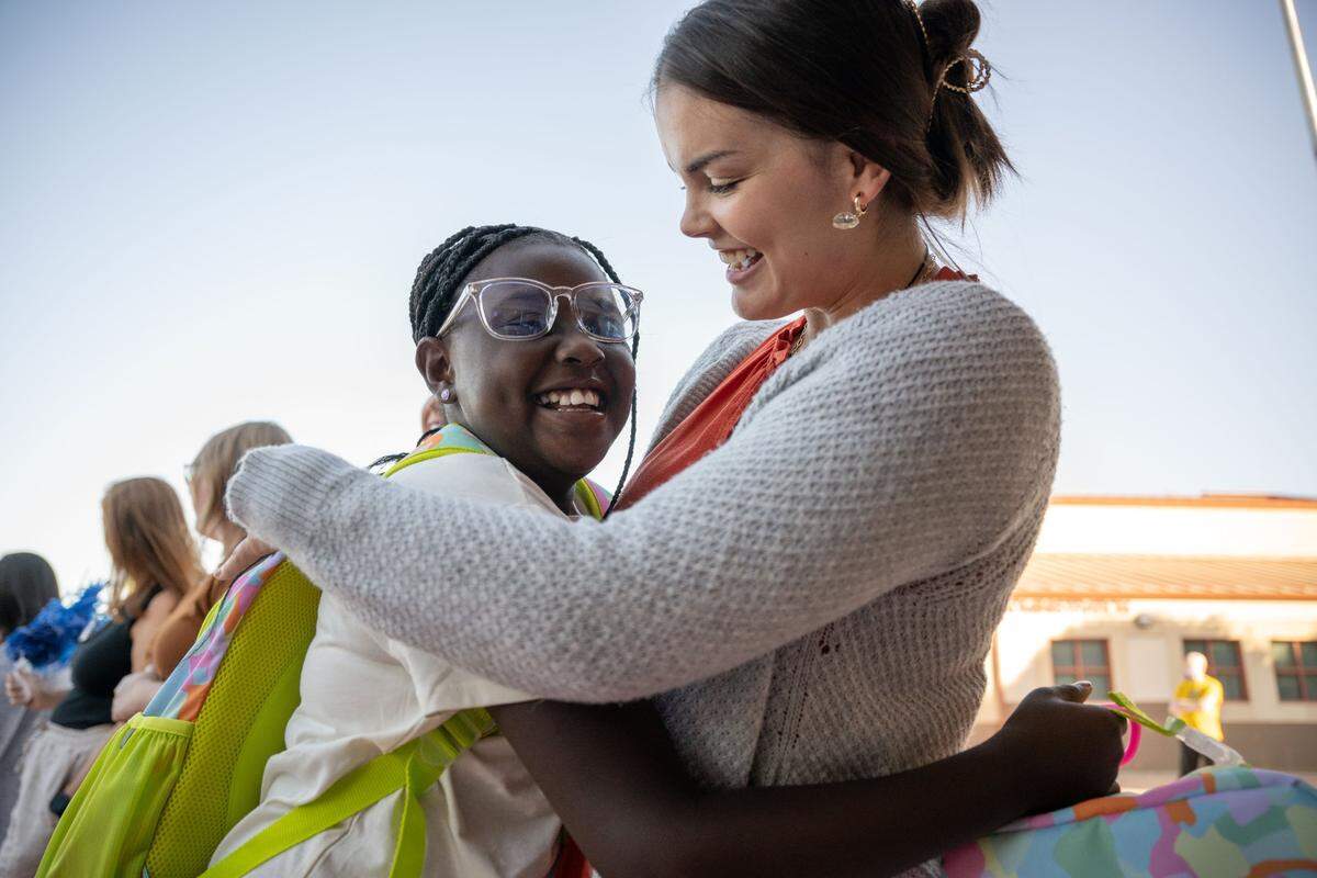 Savannah, left, a student at Navigator Elementary School, hugs teacher Elizabeth Johnson on the first day back to school Tuesday.