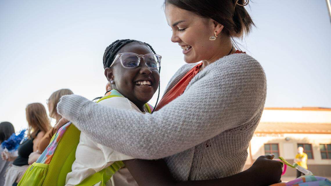 Savannah, left, a student at Navigator Elementary School in Rancho Cordova, hugs teacher Elizabeth Johnson on the first day back to school Aug. 8, 2023.