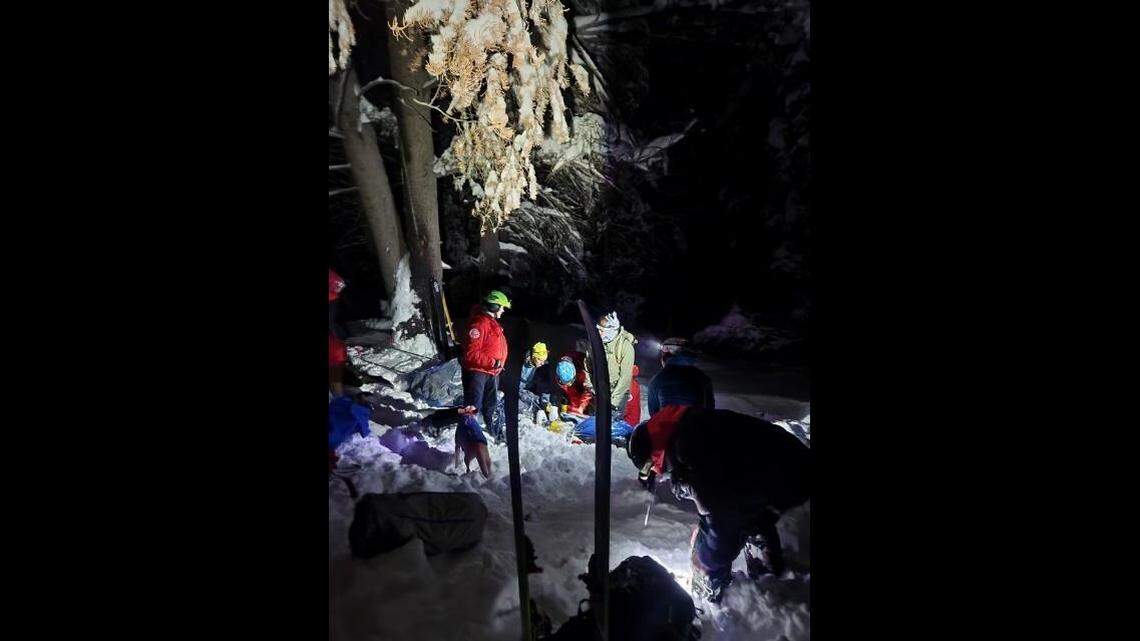 A solo skier swept away and buried chest-deep by an avalanche near Salt Lake City was saved by another skier, Utah officials say.