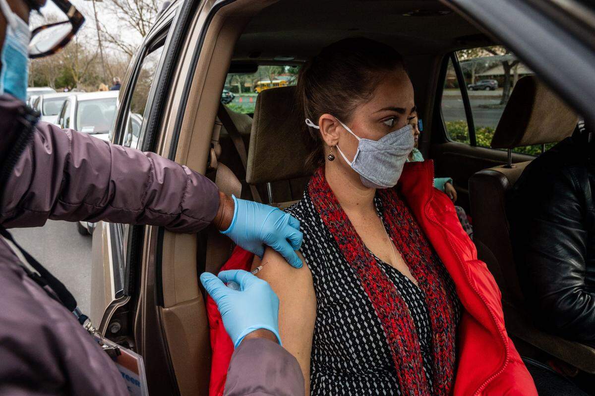 Kristin Smith, a second grade teacher at H. Allen Hight Elementary, gets the Pfizer COVID-19 vaccine at Natomas High School on Thursday, Feb. 18, 2021.
