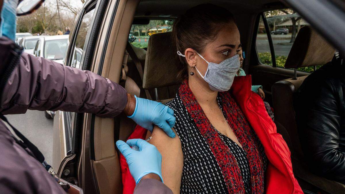 Kristin Smith, a second grade teacher at H. Allen Hight Elementary, gets the Pfizer COVID-19 vaccine at Natomas High School on Thursday, Feb. 18, 2021.