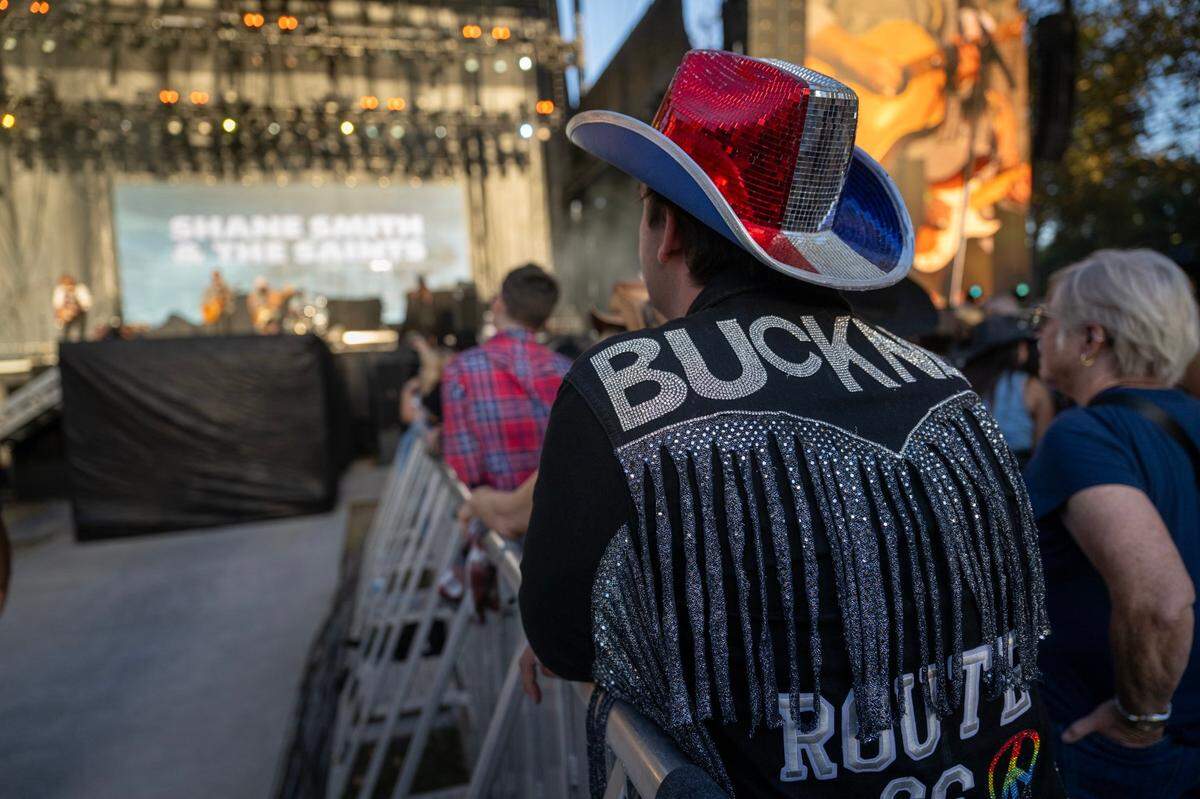 Trevor Buckner wears a custom jacket with his name listening to Shane Smith & The Saints during the GoldenSky Country Music Festival at Discovery Park in Sacramento on Friday.