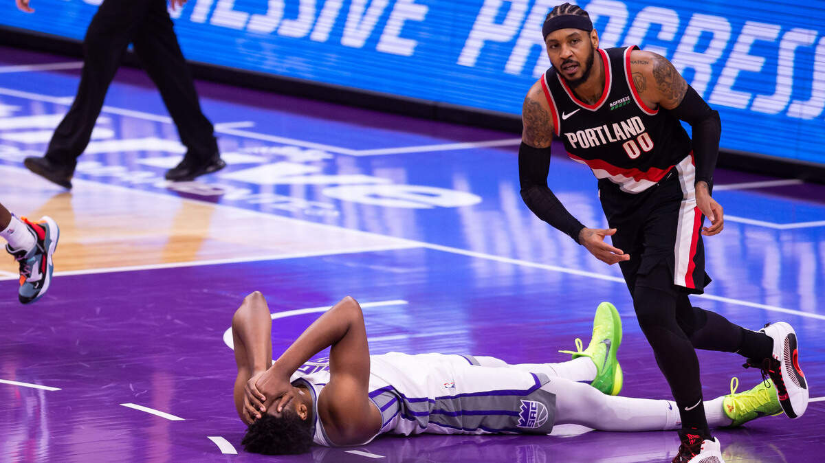 Sacramento Kings center Hassan Whiteside (20) lays on the ground after a foul-less contact with Portland Trail Blazers forward Carmelo Anthony (00) during the second half of the NBA game Saturday, Jan. 9, 2021, at Golden 1 Center in Sacramento.