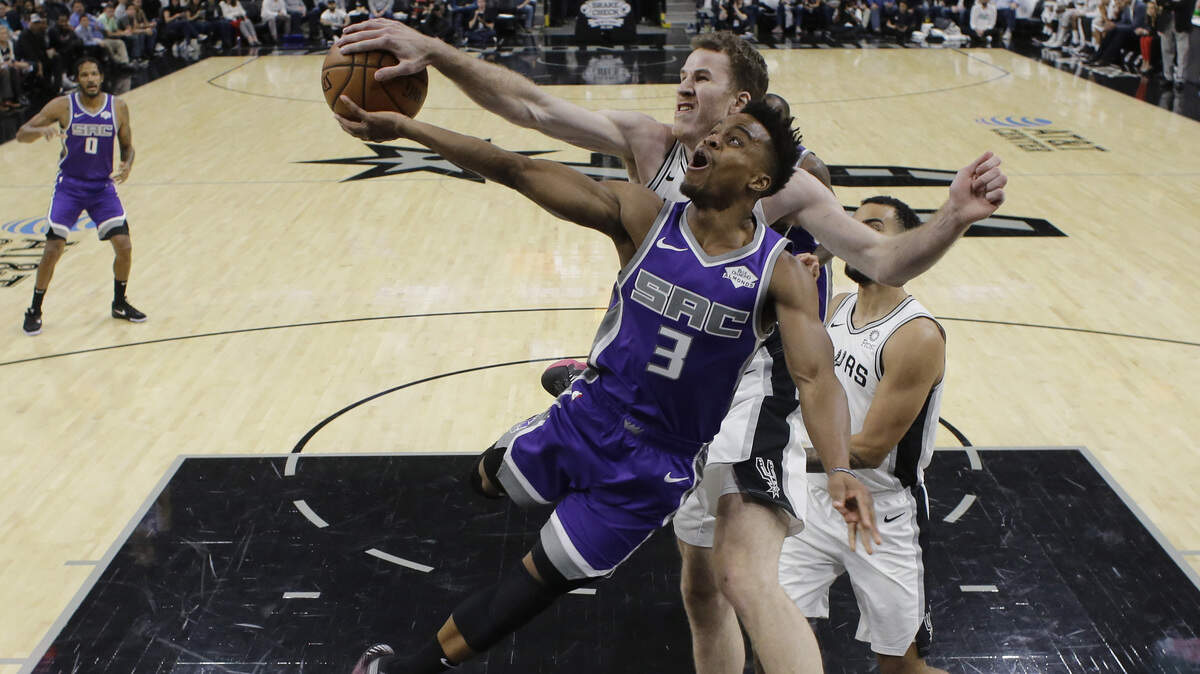 Sacramento guard Yogi Ferrell is blocked by San Antonio center Jakob Poeltl on Friday.
