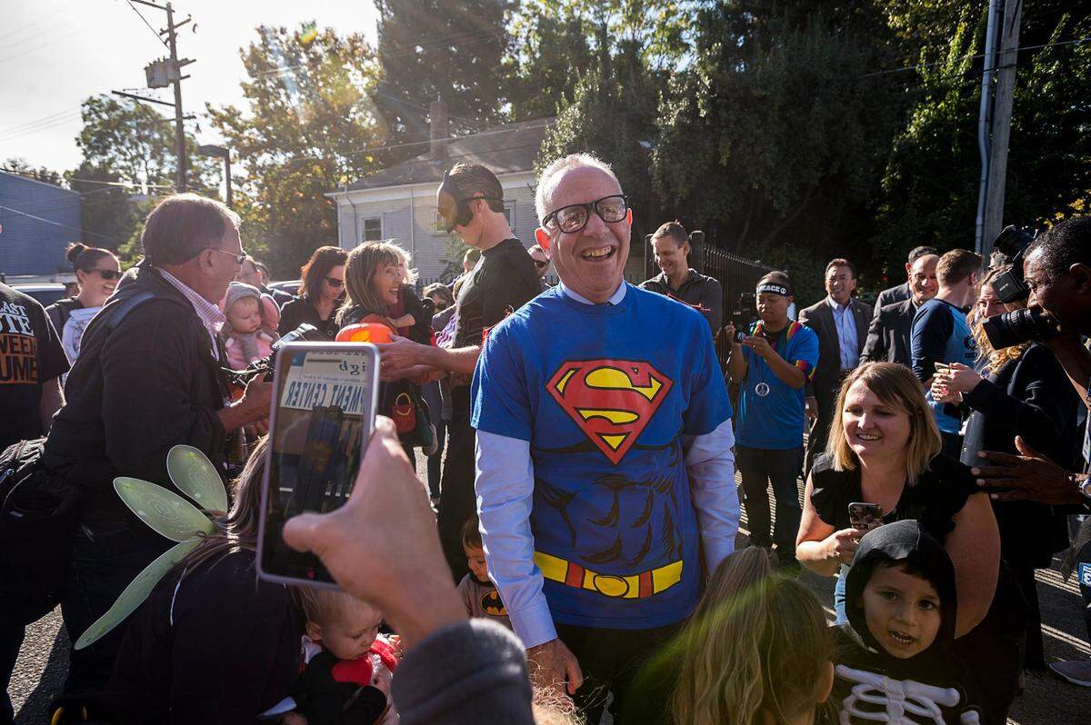 Sacramento Mayor Darrell Steinberg, dressed as Superman, greets children attending a Halloween party at the Penleigh Child Development Center on Oct. 31, 2018 in Sacramento. Then-Lt. Gov. Gavin Newsom wears a Batman outfit in the background.