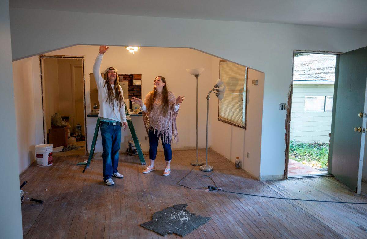 Mathew Liland and Amanda Allum talk about the work they’re doing on their recently purchased home in Carmichael on Saturday. They looked at about 35 homes before buying one at a price that was well below the median for Sacramento County.