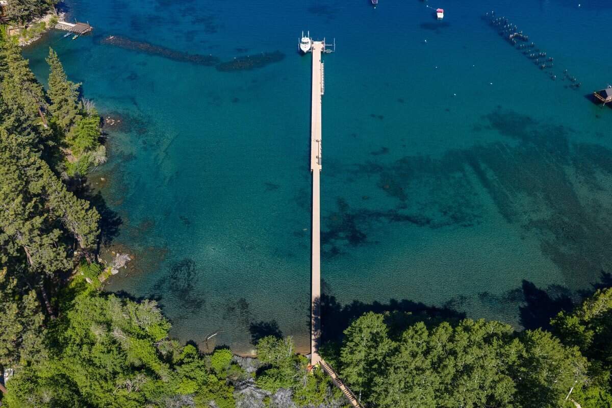 The property includes more than 425 feet of lake frontage and a 465-foot private pier, along with two boat lifts, 14 buoys and a boathouse, plus garages, support buildings and multiple recreation-oriented features.