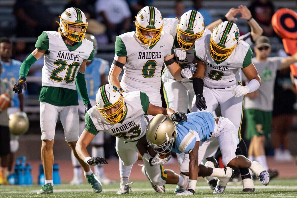 Rio Americano Raiders linebacker Toby Black (33) tackles Burbank Titans running back Trevon Edwards (3) during the first half of the high school football game at Del Campo High School on Friday, Sept. 8, 2023, in Fair Oaks.