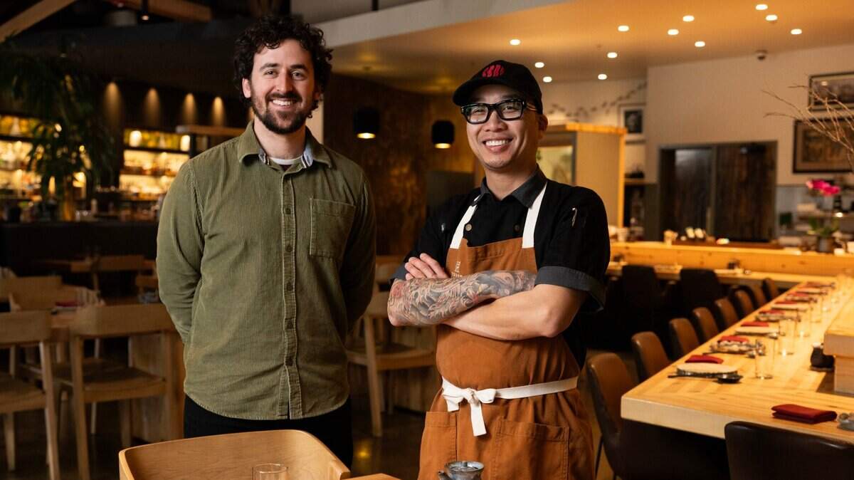 Sacramento Bee reporter Benjy Egel stands with Chef Billy Ngo, co-founder, chef and partner of Kru Contemporary Japanese Cuisine, Fish Face Poke Bar and Kodaiko Ramen & Bar inside of Kru Contemporary Japanese Cuisine in 2024.