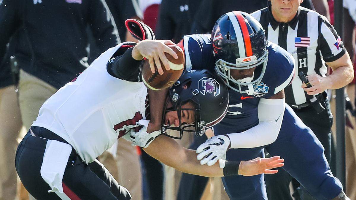 Virginia cornerback Tim Harris, right, tackles South Carolina quarterback Jake Bentley in the Belk Bowl on Dec. 29, 2018, in Charlotte, N.C. Harris was taken by the 49ers on Saturday in the sixth round of the NFL draft.
