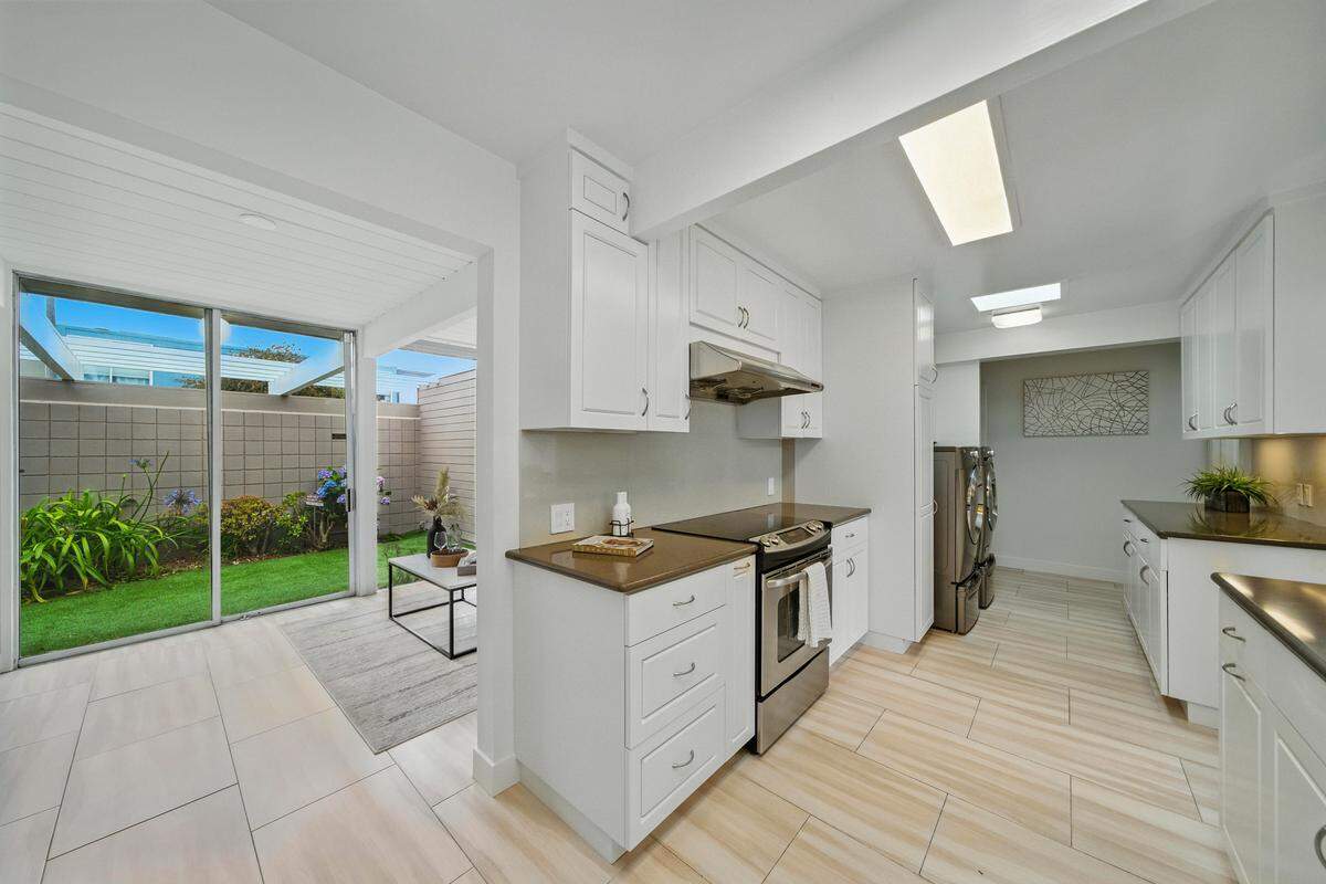 “The chef’s kitchen is outfitted with sleek stainless appliances, ample storage and generous prep space.”