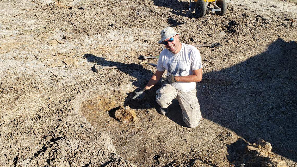 Curator Anthony Maltese showing off a bone on the site.