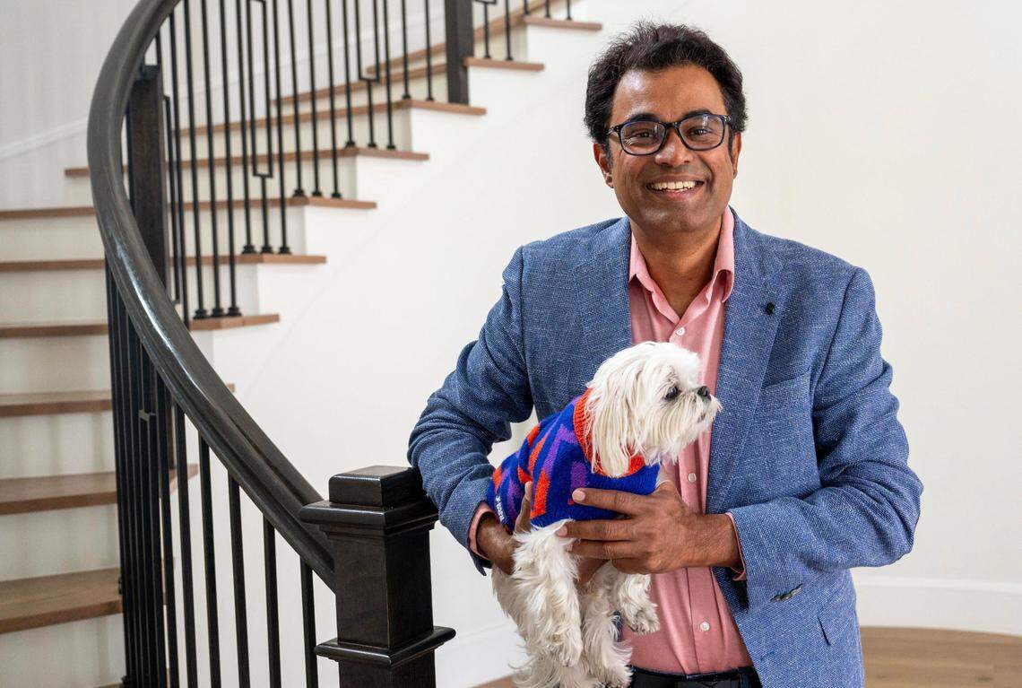 Dinakar Munagala, co-founder and CEO of AI chip maker Blaize, stands in his home in El Dorado Hills last month with his dog Sushi.