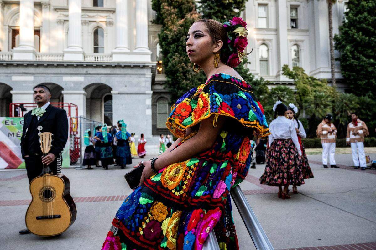 Luna Dias, 17, waits to dance with her group Insituto Mazatlan Bellas Artes de Sacramento during a celebration of the Mexican Day of Independence on the west steps of the State Capitol on Thursday, Sept. 15, 2022.