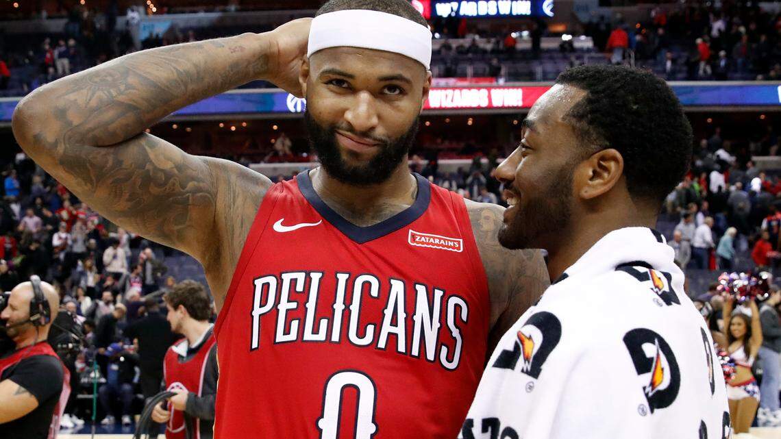New Orleans Pelicans center DeMarcus Cousins, left, reacts as he talks with Washington Wizards guard John Wall after an NBA basketball game Tuesday, Dec. 19, 2017, in Washington. The Wizards won 116-106. (AP Photo/Alex Brandon)