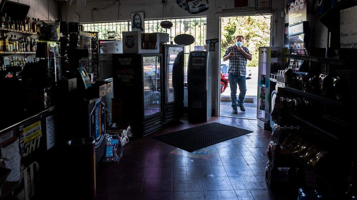 Brent Nelson of Rescue walks into 49er Liquors in Placerville on Tuesday, Sept. 8, 2020. Due to the PG&E power safety shutoff, the store had to operate in the dark and could only accept cash.