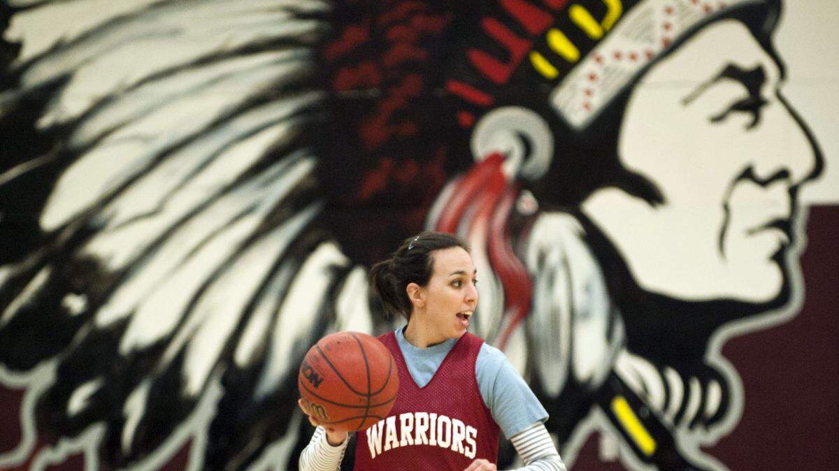 A mural depicts the Native American mascot of Hiram Johnson High School in the Sacramento school’s gym as a coach leads girls basketball practice in 2012. 
